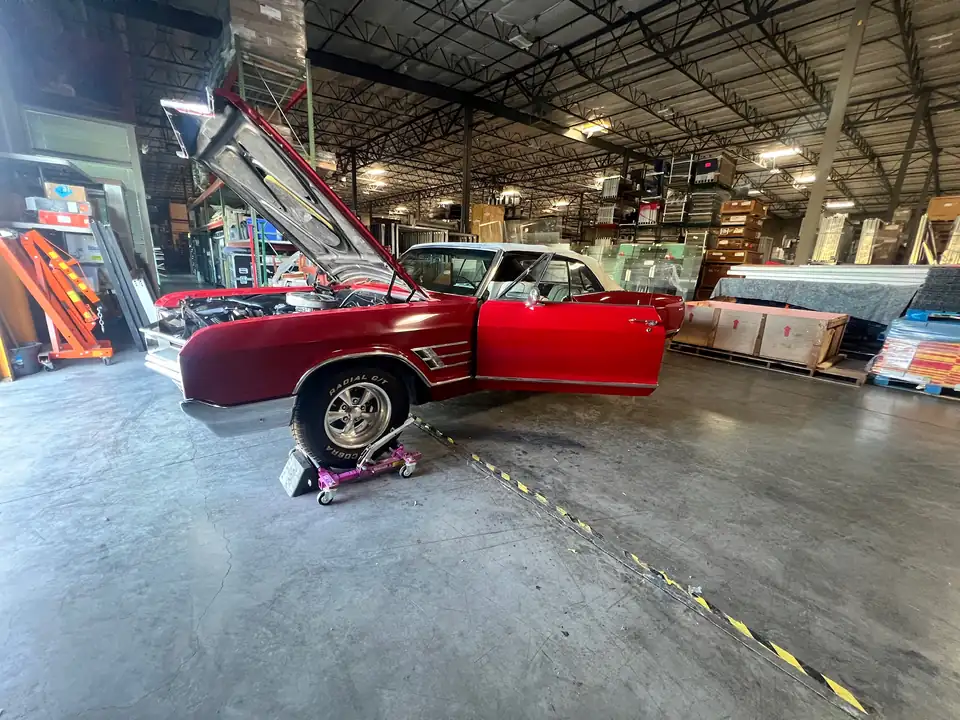CHARLOT with hood and driver door open inside a Las Vegas warehouse